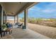 Relaxing covered outdoor patio with comfortable seating and desert landscape view at 39705 N 3Rd St, Phoenix, AZ 85086