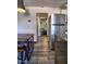 Hallway with wood-style floors that has a large stainless steel refrigerator, table, and bedroom view at 461 W Holmes Ave # 308, Mesa, AZ 85210