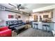 Open-concept living room with stylish furnishings, kitchen with breakfast bar, and dining area at 461 W Holmes Ave # 308, Mesa, AZ 85210