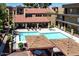 An aerial view of the community pool and spa with nearby lounging area and covered seating at 461 W Holmes Ave # 308, Mesa, AZ 85210