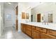 Spacious bathroom featuring dual sinks, custom wood cabinets, and a bright vanity at 4845 S Strike-It-Rich Dr, Gold Canyon, AZ 85118