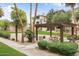 Outdoor BBQ area with picnic tables, grill, and green surroundings in a well-maintained community space at 5345 E Van Buren St # 111, Phoenix, AZ 85008