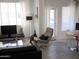 Bright living room boasting a minimalist design, large windows, and an open floor plan at 5345 E Van Buren St # 111, Phoenix, AZ 85008