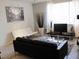 Modern living room featuring sleek furniture, a contemporary art piece, and ample natural light from large windows at 5345 E Van Buren St # 111, Phoenix, AZ 85008