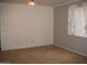 This is an empty living room featuring tile floor, large window, neutral paint, and minimal furniture at 5345 E Van Buren St # 111, Phoenix, AZ 85008