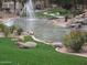 Serene pond featuring a fountain, rock features, and green landscaping, creating a peaceful outdoor space at 5345 E Van Buren St # 111, Phoenix, AZ 85008