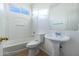 Bathroom featuring a shower-tub combo and pedestal sink at 5619 S 21St Pl, Phoenix, AZ 85040