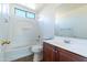 A well-lit bathroom with a tub and shower combination and vanity sink at 5619 S 21St Pl, Phoenix, AZ 85040