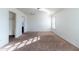 Bright bedroom featuring carpet flooring, white walls, and a built-in closet at 5619 S 21St Pl, Phoenix, AZ 85040