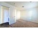 Carpeted bedroom with an attached laundry room for added convenience in this modern floor plan at 5619 S 21St Pl, Phoenix, AZ 85040