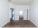 This is a bedroom with carpet, white walls, and doors leading to other rooms at 5619 S 21St Pl, Phoenix, AZ 85040