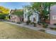 Inviting townhouse showcasing desert landscaping and mature trees in a well-maintained community at 5619 S 21St Pl, Phoenix, AZ 85040