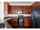 Modern kitchen featuring dark wood cabinets, sleek appliances, and granite countertops at 5619 S 21St Pl, Phoenix, AZ 85040