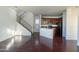 Bright living area with hardwood floors seamlessly connects to the kitchen and stairs at 5619 S 21St Pl, Phoenix, AZ 85040