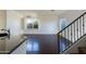 Open-concept space showcasing hardwood floors, lots of light, and staircase at 5619 S 21St Pl, Phoenix, AZ 85040