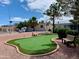 Scenic putting green with manicured lawn and seating offers a relaxing way to improve your short game at 613 Ironstone Dr, Apache Junction, AZ 85119