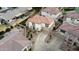 An aerial view of a two-story home with a tile roof, landscaped yard, and a long driveway leading to a two-car garage at 671 E Colt Ct, Chandler, AZ 85225
