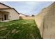 Large backyard with ample green space and a tall block wall offering a private outdoor experience at 671 E Colt Ct, Chandler, AZ 85225