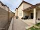 Open-air backyard with a covered patio, BBQ grill, and pavers perfect for outdoor entertaining at 671 E Colt Ct, Chandler, AZ 85225