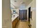 Spacious bathroom with a double sink, decorative shower curtain, and ample counter space at 671 E Colt Ct, Chandler, AZ 85225