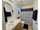 Well-lit bathroom with decorative shower curtain, large mirror and sink, and beige cabinets at 671 E Colt Ct, Chandler, AZ 85225