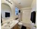 Bright bathroom with a decorative shower curtain, large mirror and sink, and beige cabinets at 671 E Colt Ct, Chandler, AZ 85225