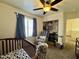 Cozy Bedroom with a ceiling fan, closet space, and comfortable seating, perfect for a new baby at 671 E Colt Ct, Chandler, AZ 85225