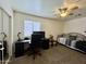 Bedroom featuring a modern desk, plush daybed, mirrored closet, and neutral color palette at 671 E Colt Ct, Chandler, AZ 85225