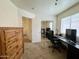 Spacious bedroom with a wood dresser, carpet flooring, and neutral colored walls with natural light at 671 E Colt Ct, Chandler, AZ 85225