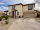 Front exterior view showcasing a two-story home with a tile roof, manicured landscaping, and a long driveway at 671 E Colt Ct, Chandler, AZ 85225
