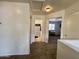 Hallway with neutral walls and carpet flooring, leading to a bathroom and a bedroom with natural light at 671 E Colt Ct, Chandler, AZ 85225