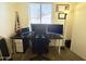 Home office with a modern desk setup, carpeted floors, and natural light from the window at 671 E Colt Ct, Chandler, AZ 85225