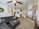 Open concept living room with cozy gray sectional sofa and carpet floors at 671 E Colt Ct, Chandler, AZ 85225