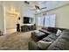 Spacious living room with sectional sofa, TV, and bright natural lighting at 671 E Colt Ct, Chandler, AZ 85225