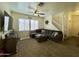 Comfortable living room with large sectional sofa, ceiling fan, and staircase at 671 E Colt Ct, Chandler, AZ 85225