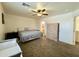 Main bedroom with a ceiling fan, carpet, and good view into the bathroom at 671 E Colt Ct, Chandler, AZ 85225