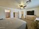 Main bedroom with ceiling fan, carpet, and good view into bathroom and hallway at 671 E Colt Ct, Chandler, AZ 85225