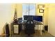 A well-lit home office with a large monitor setup, a comfortable chair, and natural light from a window at 671 E Colt Ct, Chandler, AZ 85225