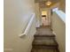 Carpeted stairway with a white banister leading to the upper level, with neutral walls and natural light at 671 E Colt Ct, Chandler, AZ 85225