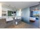 A well-lit bathroom with double sinks, large mirrors, and glass door entrance to the main bedroom at 6850 E Main St # 4404, Scottsdale, AZ 85251