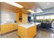 Modern kitchen featuring an island with seating, sleek appliances, and bright yellow cabinetry at 6850 E Main St # 4404, Scottsdale, AZ 85251