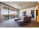 Modern living room with exposed concrete ceilings, a comfortable gray sofa, and sliding doors to a balcony with mountain views at 6850 E Main St # 4404, Scottsdale, AZ 85251
