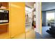 A modern, open refrigerator showcases food and beverages, located next to the microwave and yellow shelving at 6850 E Main St # 4404, Scottsdale, AZ 85251