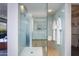 The modern shower is decorated with blue tiling, and has white robes hanging for spa-like ambience at 6850 E Main St # 4404, Scottsdale, AZ 85251