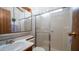 Bathroom with shower, tile and vanity. It has a wooden door and handle at 711 Felspar Dr, Apache Junction, AZ 85119