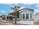 Charming single-story home featuring a carport, desert landscaping, and palm tree at 711 Felspar Dr, Apache Junction, AZ 85119
