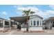 Charming single-story home featuring a carport, desert landscaping, and palm tree at 711 Felspar Dr, Apache Junction, AZ 85119