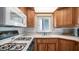 Well-maintained kitchen featuring wood cabinets, white appliances, and ample natural light at 711 Felspar Dr, Apache Junction, AZ 85119