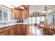 Kitchen and living area with wood cabinets, white countertops, and bright natural light at 711 Felspar Dr, Apache Junction, AZ 85119