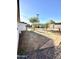 Spacious backyard featuring drought-tolerant landscaping, brick accents, and potential for outdoor enjoyment at 7754 W Mitchell Dr, Phoenix, AZ 85033